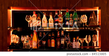 bottles of liqour on shelf in bar at night bottles of liqour on shelf in bar at night 84513805