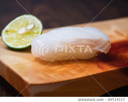 Nigiri sushi with stones on top of sushi clogs. Nigiri sushi with stones on top of sushi clogs. 84514317
