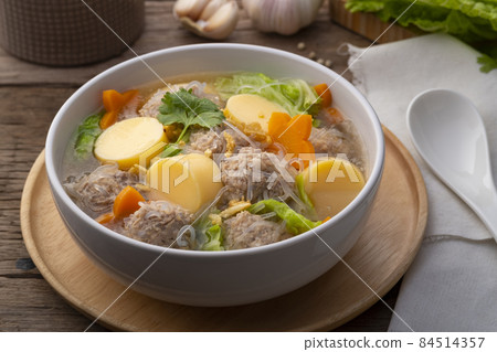 Close up Clear glass noodle soup with Minced Pork,Vegetables and egg tofu (Gaeng Jued Woon Sen) 84514357