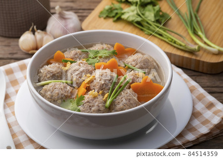 Close up Clear glass noodle soup with Minced Pork and carrot.Asian Meatball Soup with cellophane noodle (Gaeng Jued Woon Sen) 84514359