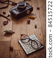 Autumn image photo of retro film camera and glasses 84515722
