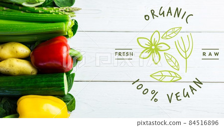 Overhead view of fresh vegetables with organic vegan text sign on wooden table 84516896