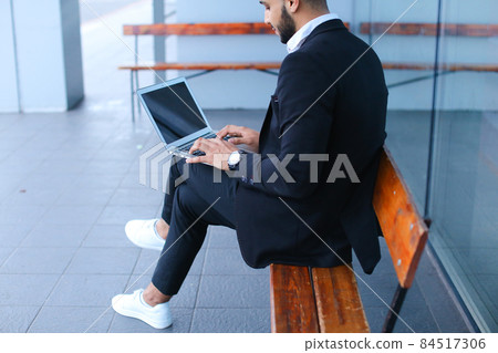 Cool guy arabic man uses laptop business center Cool guy arabic man uses laptop business center 84517306