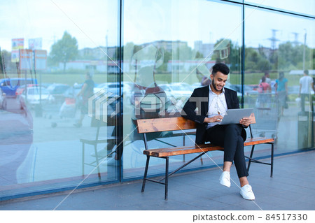 Cool guy arabic man uses laptop business center 84517330