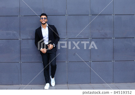 Arabic guy in business center stands smiling walking slow Arabic guy in business center stands smiling walking slow 84519352