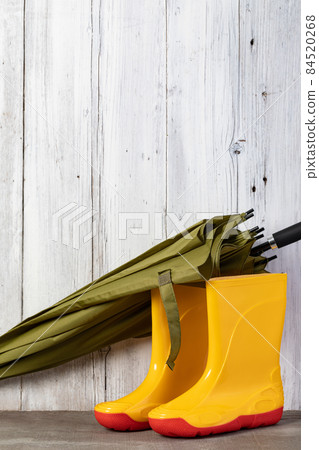 green umbrella and gumboots green umbrella and gumboots 84520268