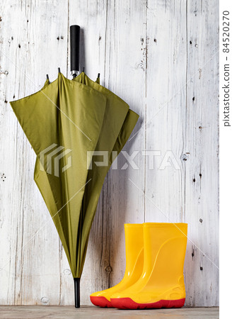 green umbrella and gumboots 84520270