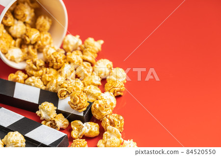 Sweet caramel popcorn and clapper board 84520550