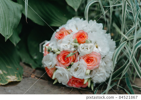 The wedding bouquet of the bride lies on the stone floor. culture, wedding ethical traditions concept. The wedding bouquet of the bride lies on the stone floor. culture, wedding ethical traditions concept. 84521867