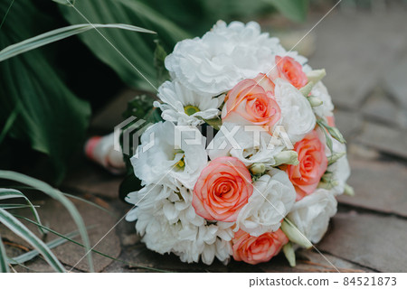 The wedding bouquet of the bride lies on the stone floor. culture, wedding ethical traditions concept. 84521873