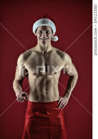 Sexy muscular man in santa hat. Christmas shopping. Sexy muscular man in santa hat. Christmas shopping. 84521880