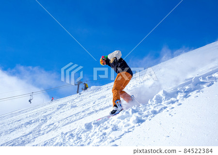 Snowboarder sliding new snow 84522384