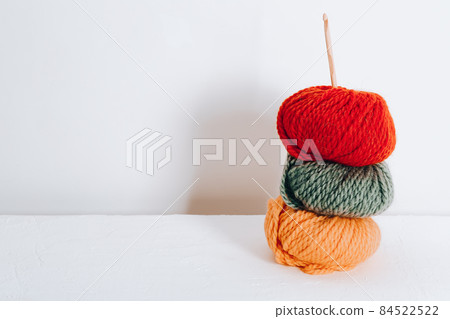 Balls of wool for knitting in autumn colors on a white background Balls of wool for knitting in autumn colors on a white background 84522522
