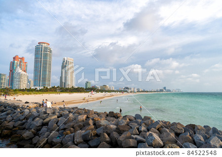 Miami, USA - April 19, 2021: sea beach and cityscape. Beach resort on urban skyline Miami, USA - April 19, 2021: sea beach and cityscape. Beach resort on urban skyline 84522548