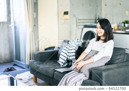 Young woman watching TV at home 84522700