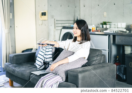 Young woman watching TV at home 84522701