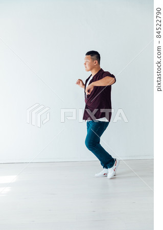 Asian man dancing to music alone at home Asian man dancing to music alone at home 84522790
