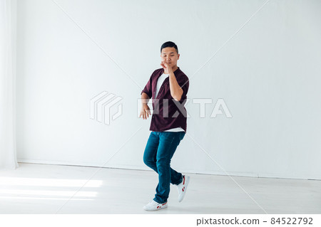 Asian man dancing to music alone at home Asian man dancing to music alone at home 84522792