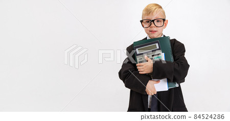 Flyer with cute little boy, kid businessman in huge suit jacket wearing eyeglasses isolated on white studio background. Flyer with cute little boy, kid businessman in huge suit jacket wearing eyeglasses isolated on white studio background. 84524286