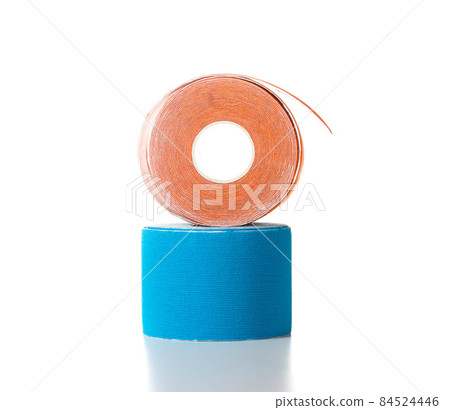 Blue and orange medical kinesiology tape on a white background. Isolate, teping, close-up 84524446
