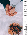 Man warms hands of a woman in his hands. winter hike theme 84524643