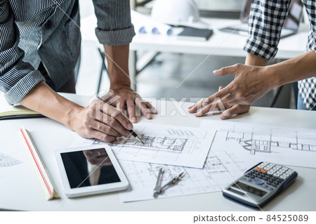 Construction concept of Engineer or architect meeting for project working with partner and engineering tools on model building and blueprint in working site 84525089