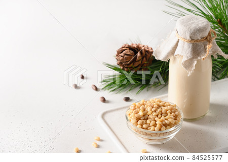 Vegan cedar milk on white background. Non dairy alternative milk. Vegan cedar milk on white background. Non dairy alternative milk. 84525577