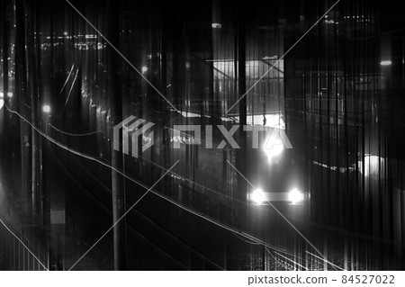 單色鐵路風景 黃昏貨運列車 帶有電力機車深沉低音的黃昏 黑暗的鐵路設施和前燈 84527022