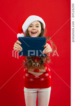 Happy winter holidays. Small girl. Little girl child in santa red Happy winter holidays. Small girl. Little girl child in santa red 84528200