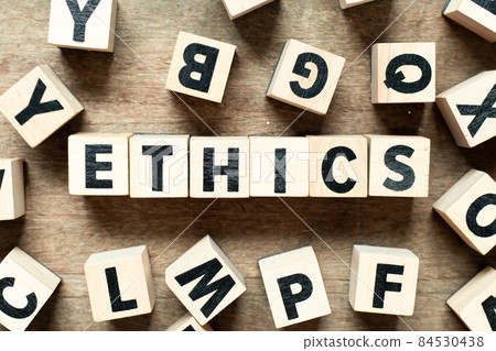 Alphabet letter block in word ethics with another block on wood background Alphabet letter block in word ethics with another block on wood background 84530438