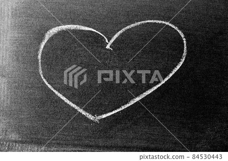White color chalk hand drawing in heart shape on blackboard or chalkboard background White color chalk hand drawing in heart shape on blackboard or chalkboard background 84530443