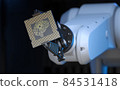 Robotic Arm Holding an Artificial Intelligence Computer Processor Unit 84531418