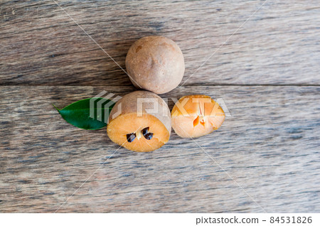 fresh sapodilla fruits on old wooden background fresh sapodilla fruits on old wooden background 84531826
