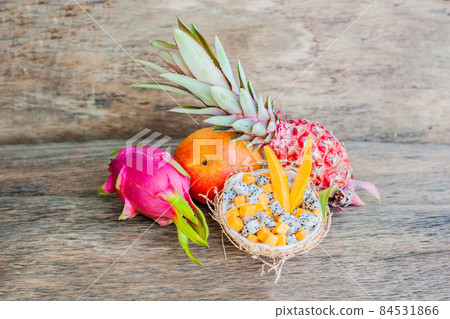 Fruit salad with dragon fruit and papaya in half a coconut 84531866