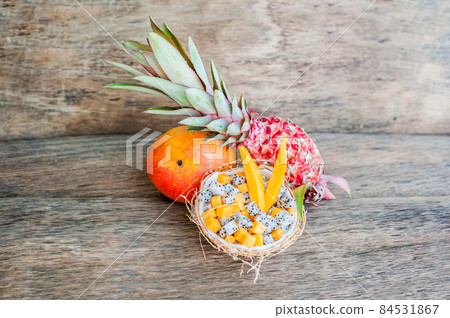 Fruit salad with dragon fruit and papaya in half a coconut 84531867