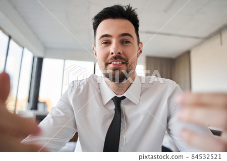 Man wearing white shirt and tie having conversation with somebody Man wearing white shirt and tie having conversation with somebody 84532521