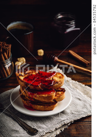 Stack of french toasts with berry syrup Stack of french toasts with berry syrup 84535792
