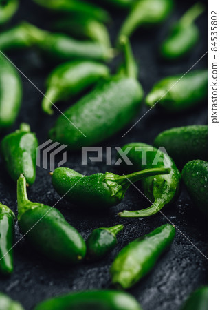 Ripe Green Jalapeno Peppers on Concrete Background 84535802