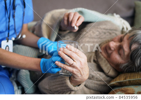 A young nurse is caring for an elderly 80-year-old woman at home. 84535956