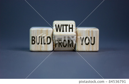 Build from or with you symbol. Turned the wooden cube and changed words 'build from you' to 'build with you'. Beautiful grey background, copy space. Business, build from or with you concept. Build from or with you symbol. Turned the wooden cube and changed words 'build from you' to 'build with you'. Beautiful grey background, copy space. Business, build from or with you concept. 84536791