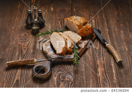 Pork collar joint baked in oven on wooden serving board Pork collar joint baked in oven on wooden serving board 84536894