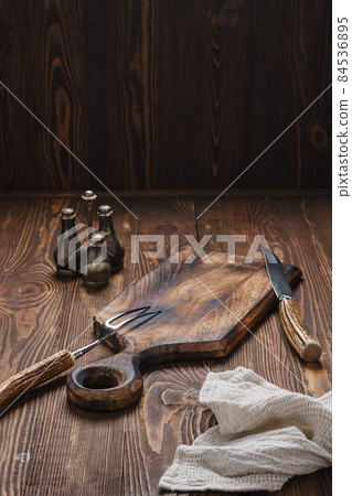 Empty wooden cutting board, fork and knife with for steak Empty wooden cutting board, fork and knife with for steak 84536895