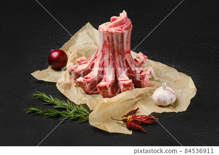 Raw lamb crown roast in wrapping paper Raw lamb crown roast in wrapping paper 84536911