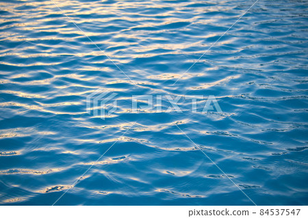 Closeup seascape surface of blue sea water with small ripple waves. Closeup seascape surface of blue sea water with small ripple waves. 84537547