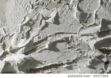 White textured clay wall design with cracks and imperfections. Wall design ideas in contemporary interior. 84537904