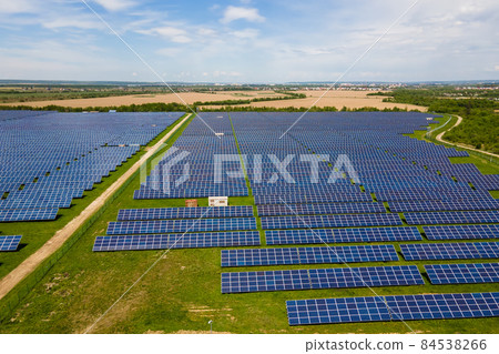 Aerial view of big sustainable electric power plant with many rows of solar photovoltaic panels for producing clean ecological electrical energy. Renewable electricity with zero emission concept. 84538266