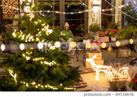 New Year's decorated backyard and woman alone 84538656