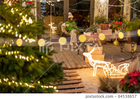 New Year's decorated backyard and woman alone New Year's decorated backyard and woman alone 84538657