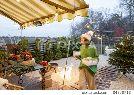 New Year's decorated backyard with a woman walking New Year's decorated backyard with a woman walking 84538718