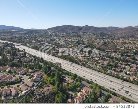 Aerial view of highway with traffic surrounded by houses, Interstate 15 with in vehicle movement. Aerial view of highway with traffic surrounded by houses, Interstate 15 with in vehicle movement. 84538878